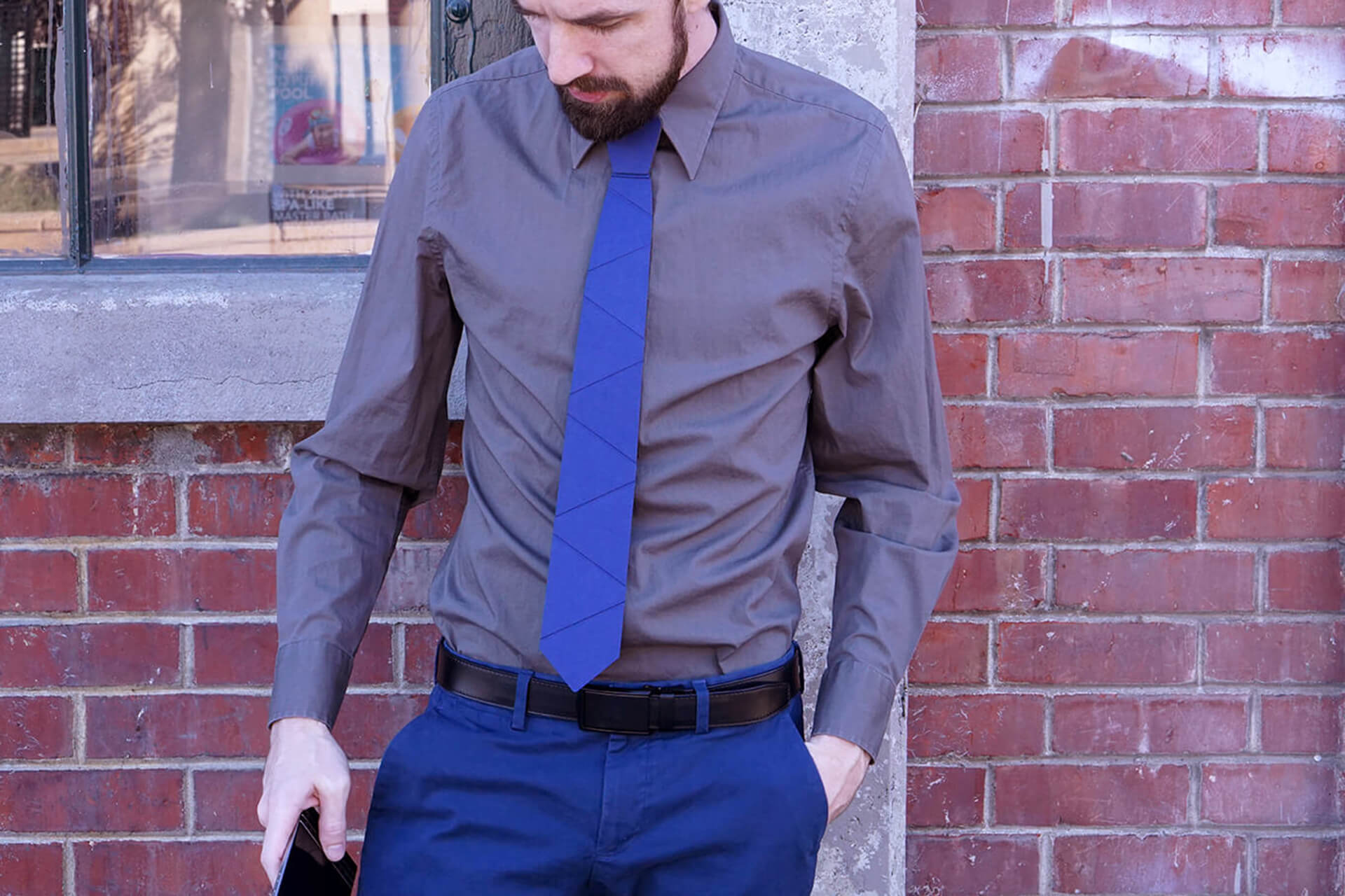 A lifestyle shot showing off a blue cardboard tie on a sexy man