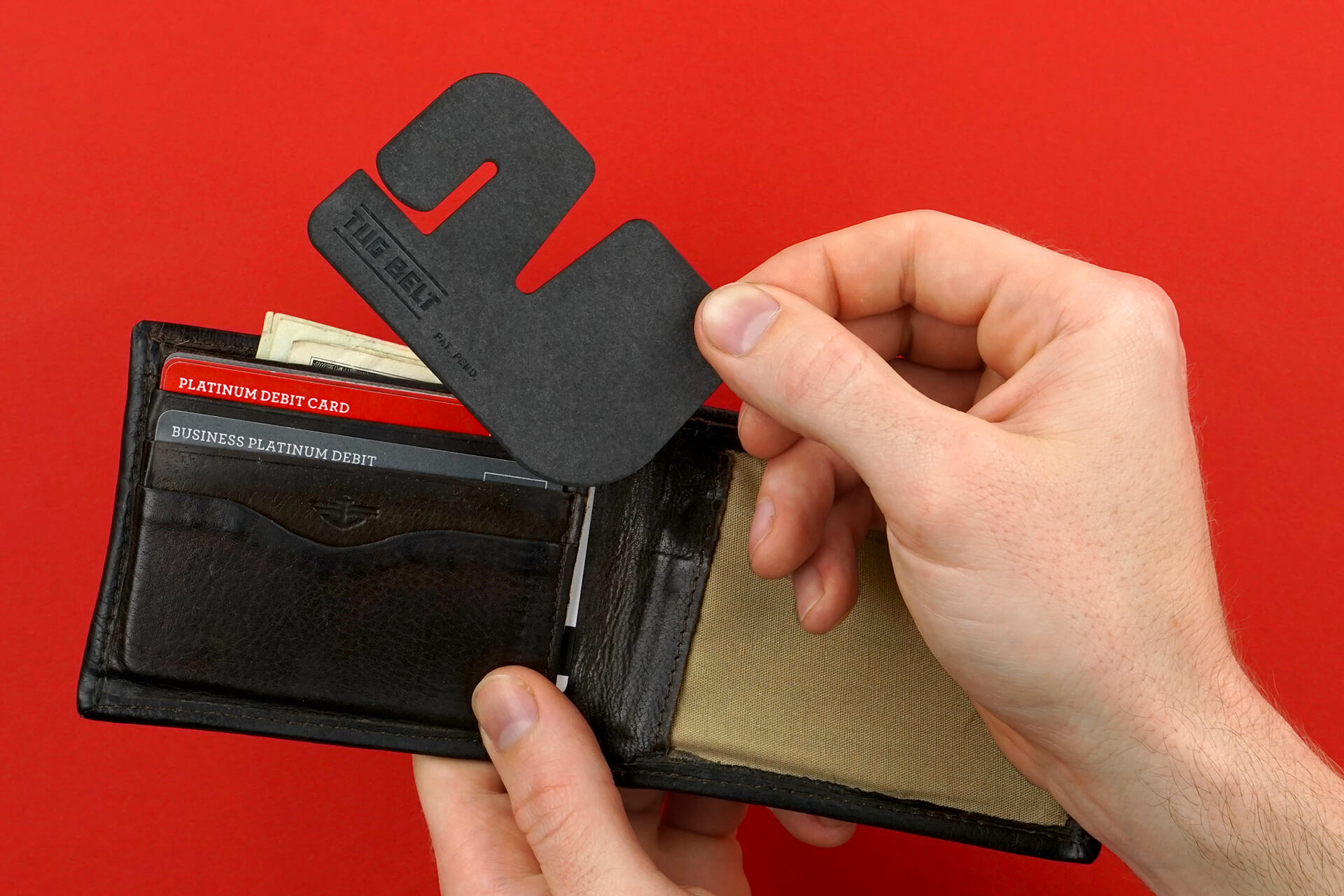 The Tug Belt being taken out of a wallet