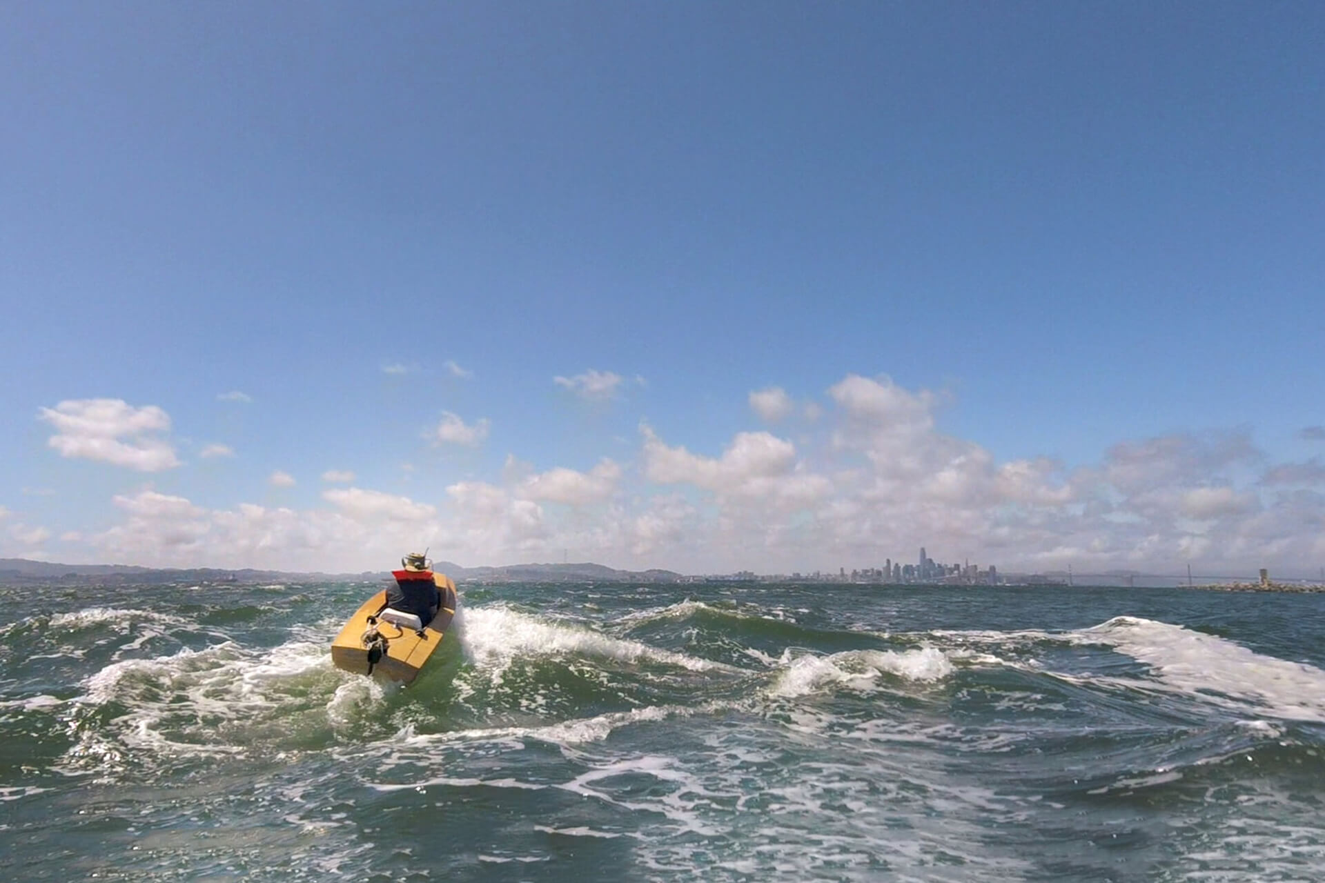 Dylan pushing his mini boat to the limits in the San Francisco Bay chop