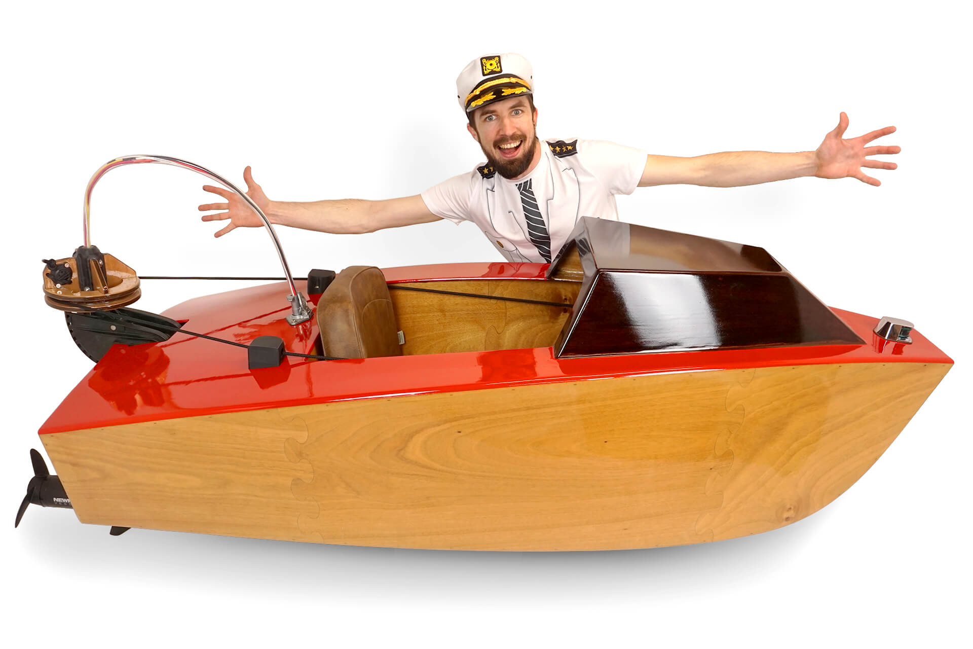 A hero shot of the laser cut mini boat with the creator behind it